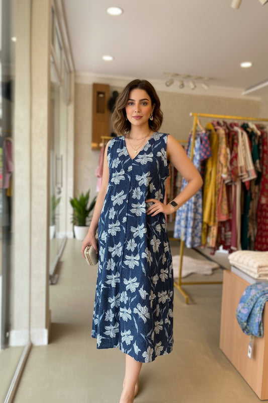 Mannequin wearing a blue floral dress in a store setting