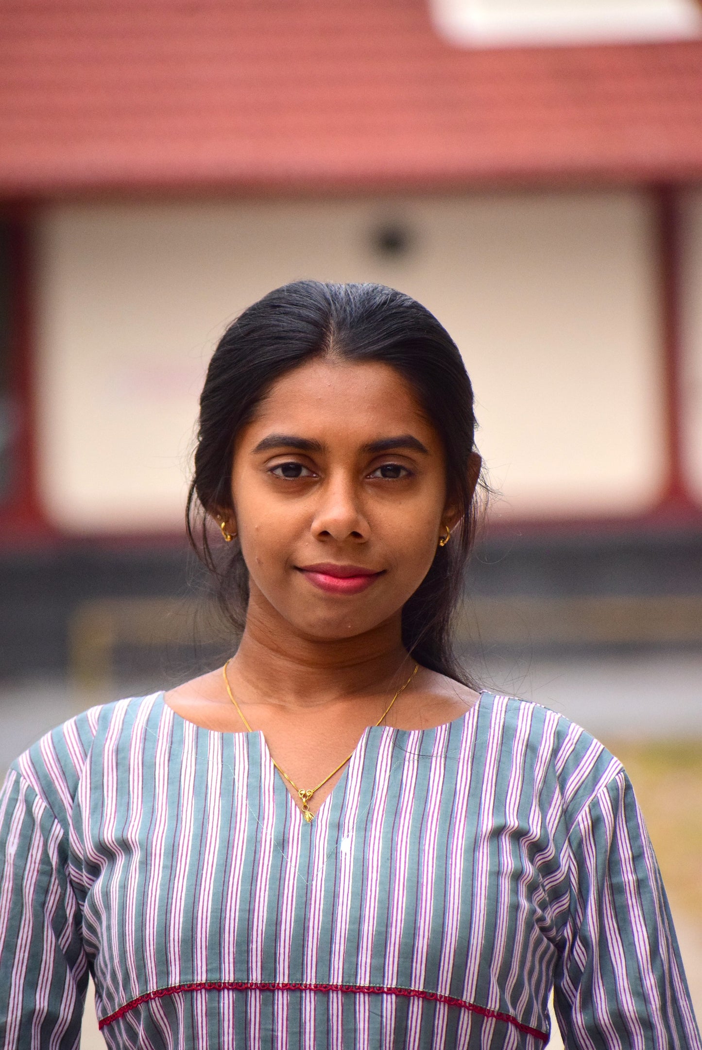 Woman wearing a striped shirt with a blurred background