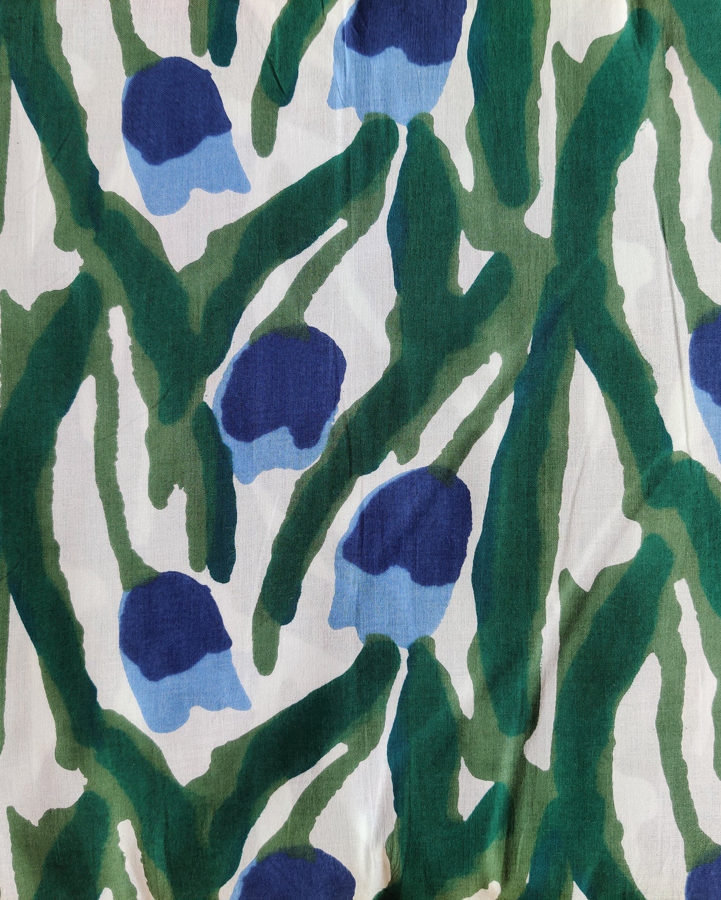 Pattern of blue flowers and green stems on a white background