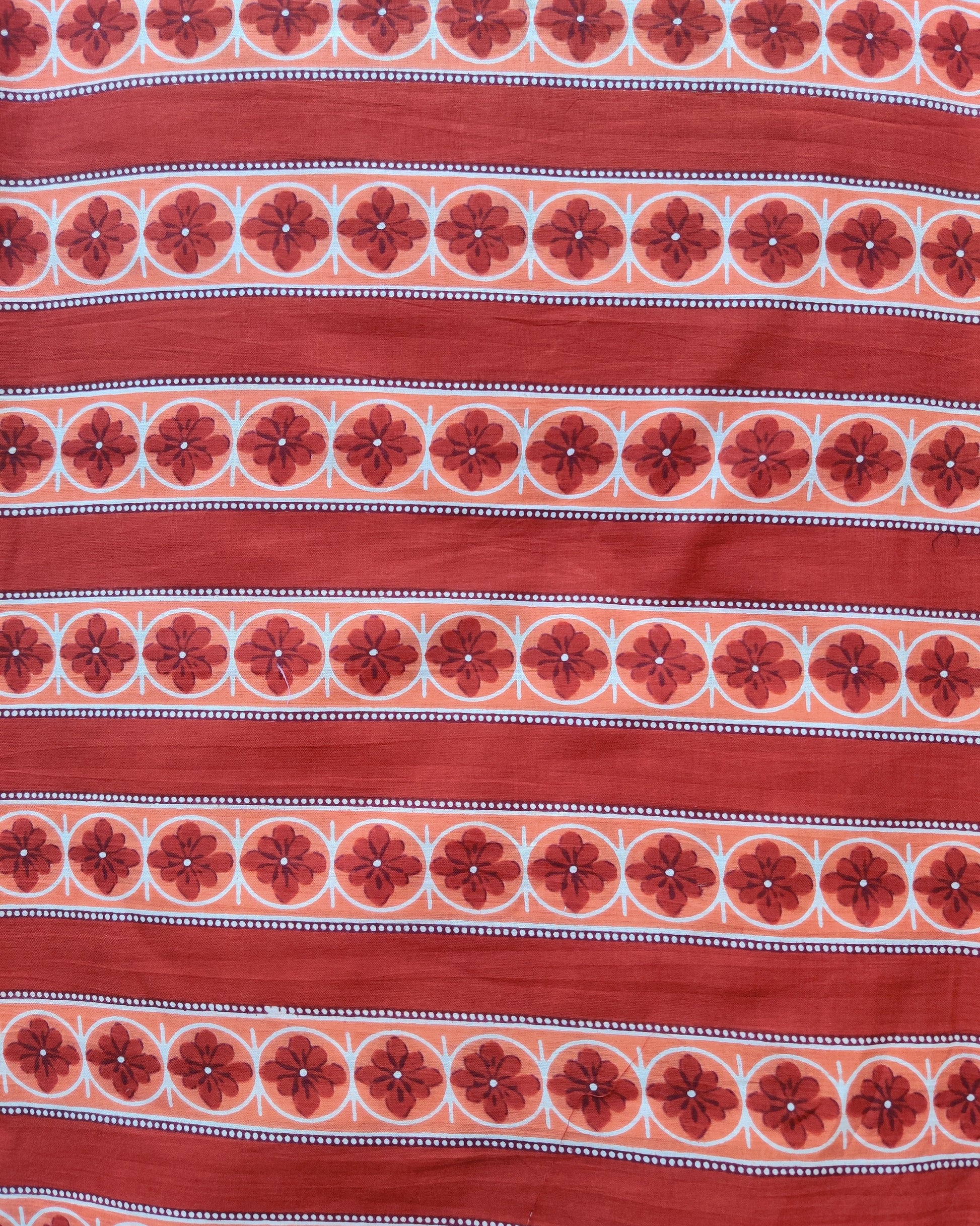 Red fabric with floral pattern and white stripes