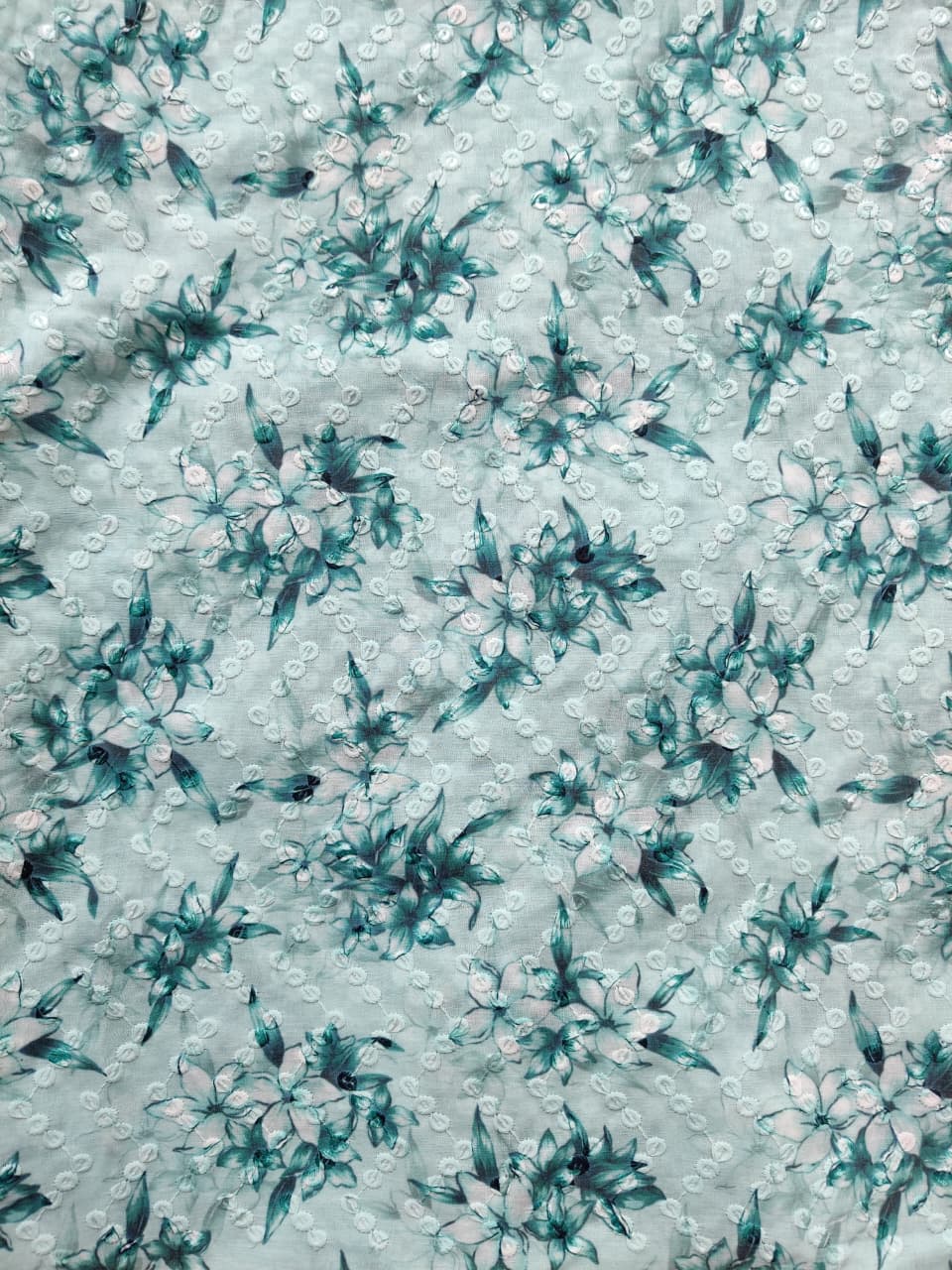 Teal floral pattern on a light blue background