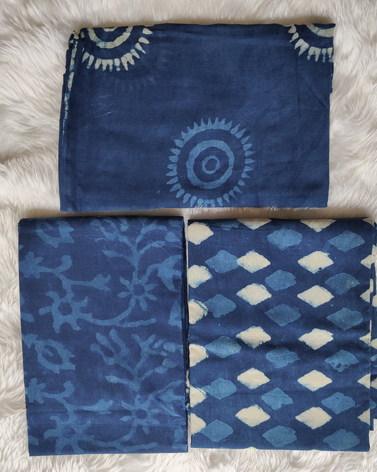 Four blue patterned cloths on a white fluffy surface
