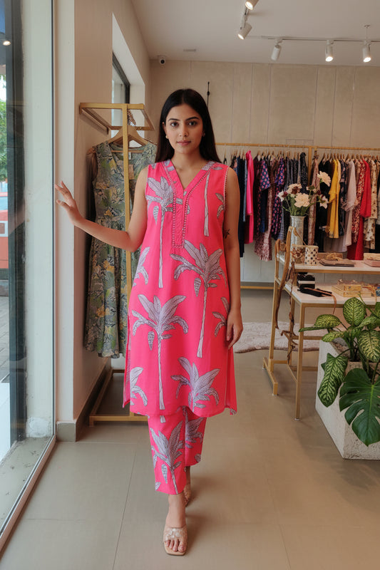Red garment with floral patterns on a glass surface, held by a hand.